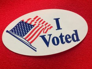 "I voted" sticker on red fabric