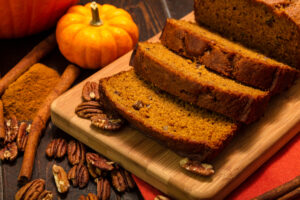 Pumpkin,Bread,Loaf,Sitting,On,Wooden,Cutting,Board,With,Pecan